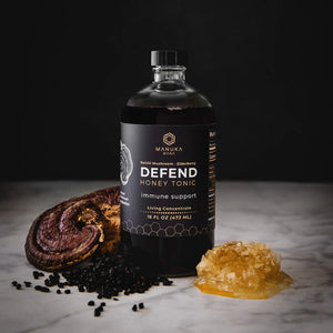 DEFEND, Manuka Mana's red reishi tonic, is pictured with its ingredients--red reishi mushrooms, elderberry, and manuka honey.